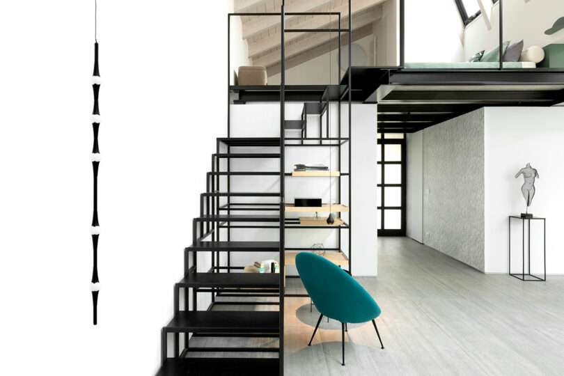 front view of modern black metal sculptural staircase in modern apartment