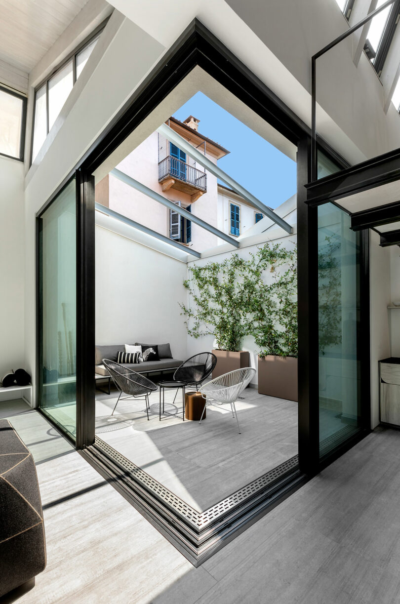 interior shot of modern apartment with square interior courtyard that opens up to living space