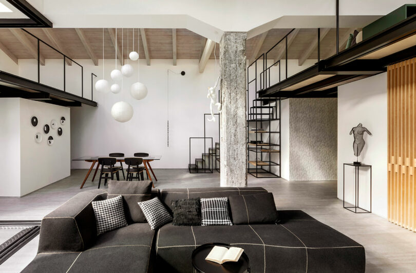 interior shot of large open loft apartment with black and white furnishings