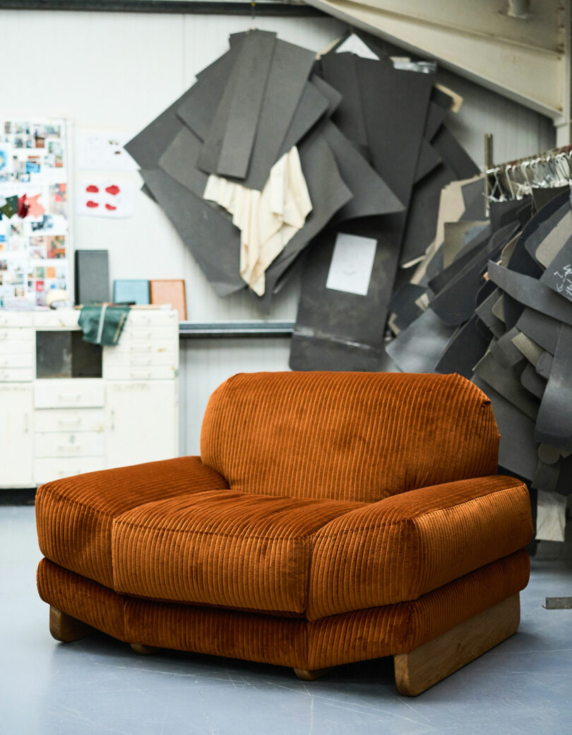 The front of an oversized corduroy lounge chair in a studio space.