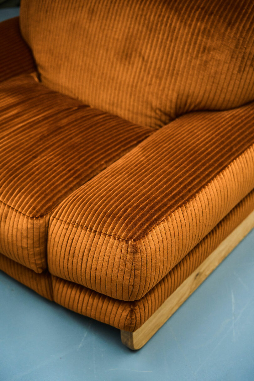 Detail of an oversized corduroy lounge chair in a studio space.