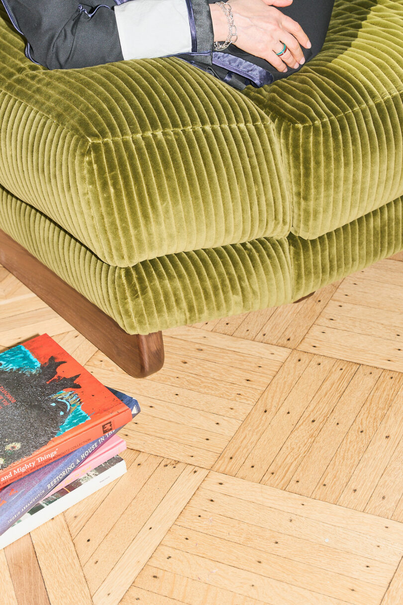 Detail of an oversized corduroy lounge chair in a studio space.