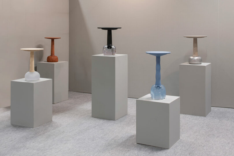 A variety of side tables presented on pedestals.