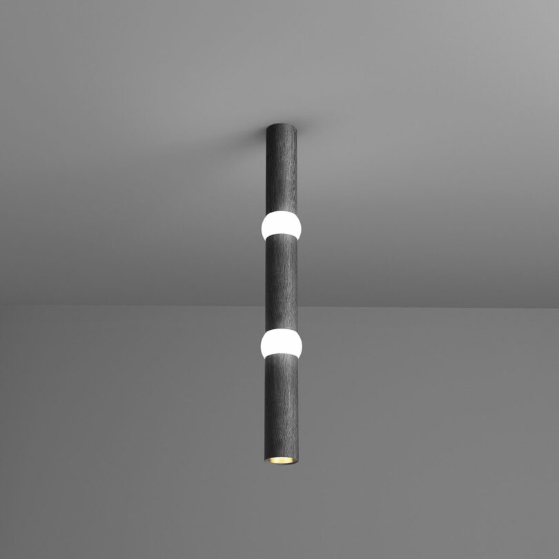 A contemporary stick light protruding from the ceiling.