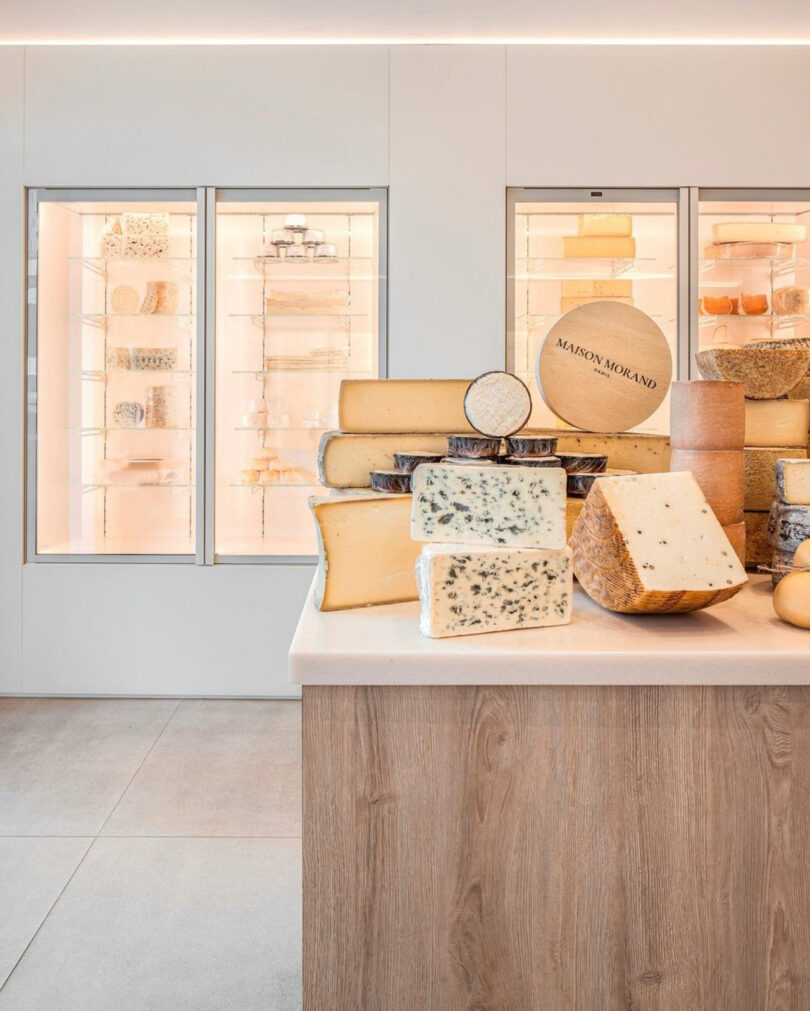 Partial interior view of modern cheese shop in Paris with blocks of cheese on counter
