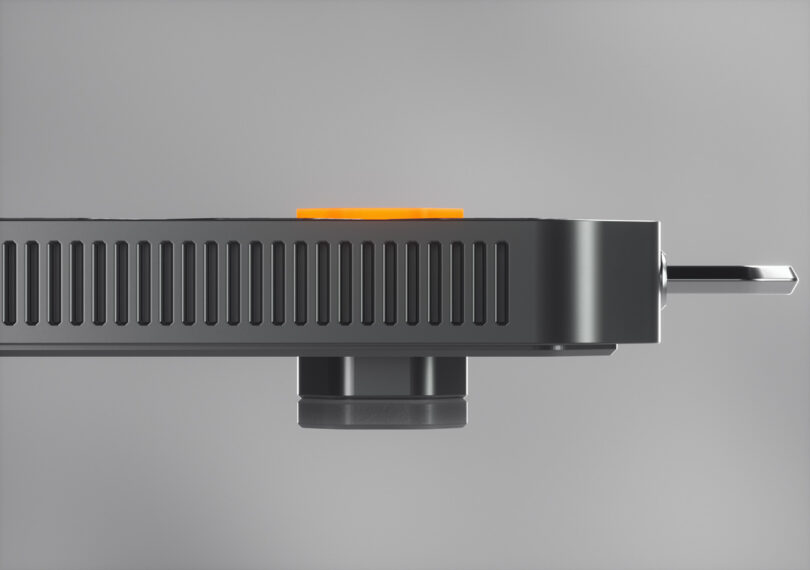 Side view of venting detail and keyboard feet, with orange backlit ESC button profile visible