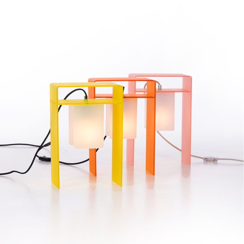 yellow orange and pink table lamps on a white surface