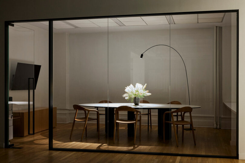 A conference table behind glass doors.