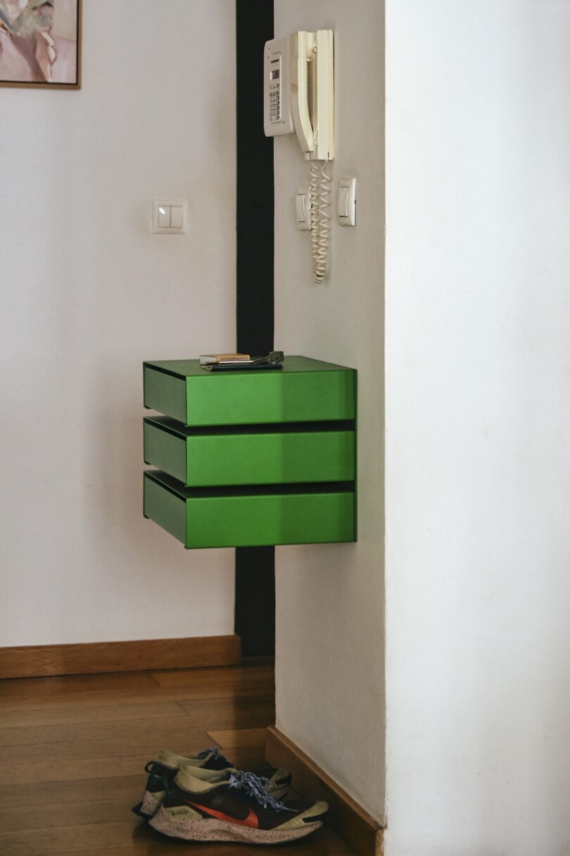 green wall mounted drawers above shoes
