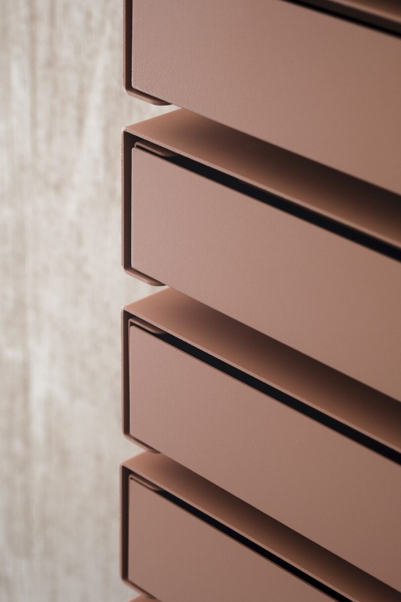 details of peach colored wall mounted drawers