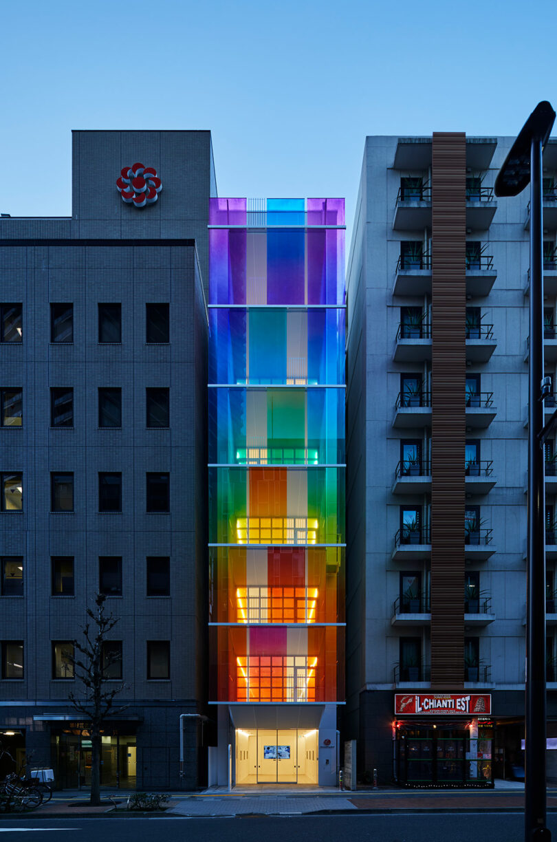 evening exterior view of modern building with rainbow fronted facade
