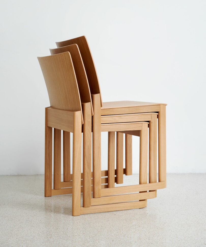 three wooden stacking chairs stacked on top of each other