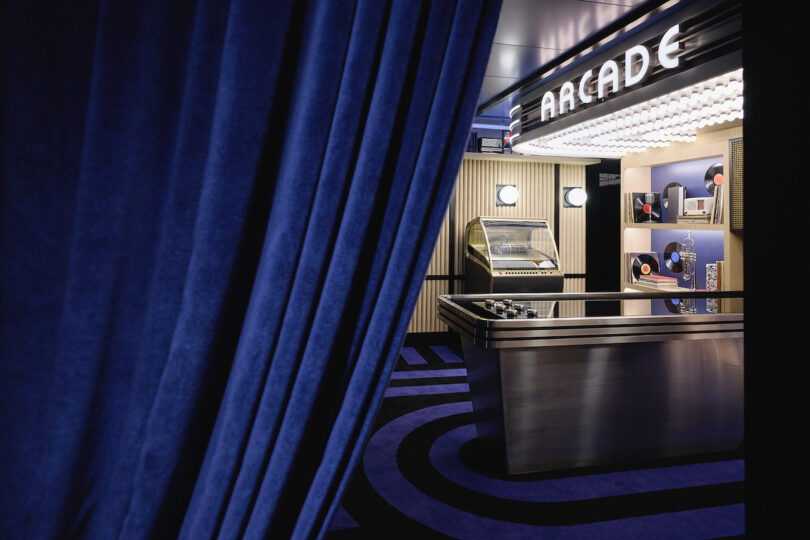 blue curtain revealing an arcade room