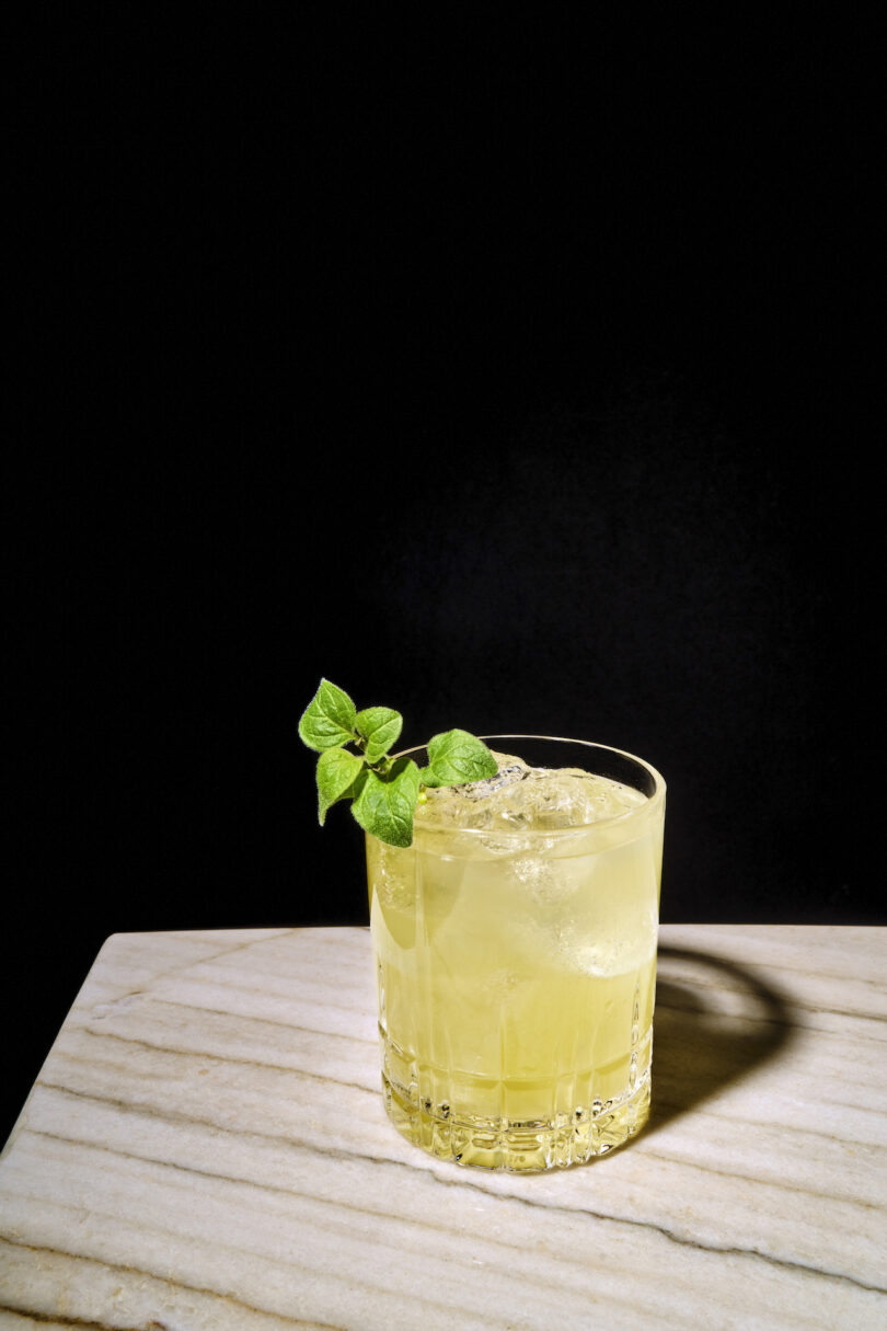 yellow cocktail with a sprig of mint