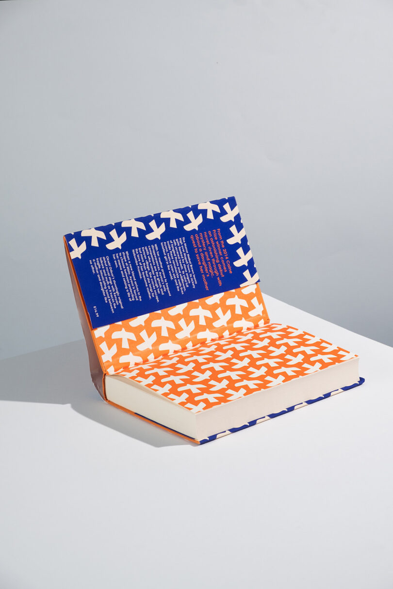 book with its cover opened showing a blue and orange illustration pattern