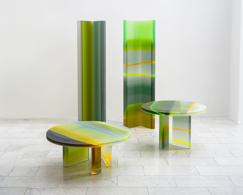 two colorful lucite coffee tables and two lucite totems