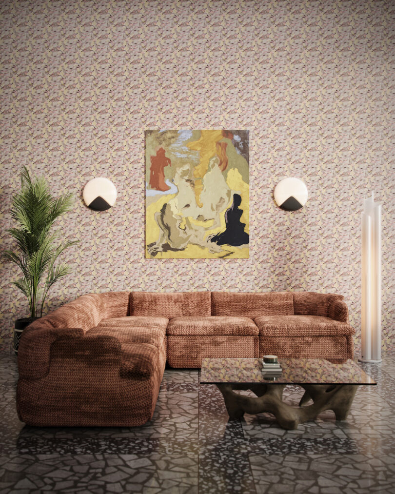 brown sectional under abstract painting in wallpapered room