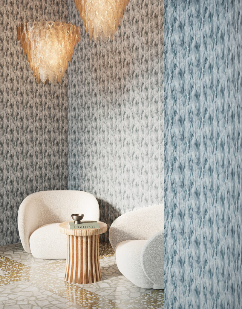 two white lounge chairs next to a wooden side table in a blue wallpapered room