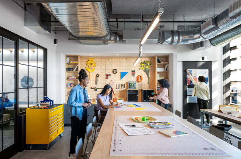 four employees in a maker space of an office