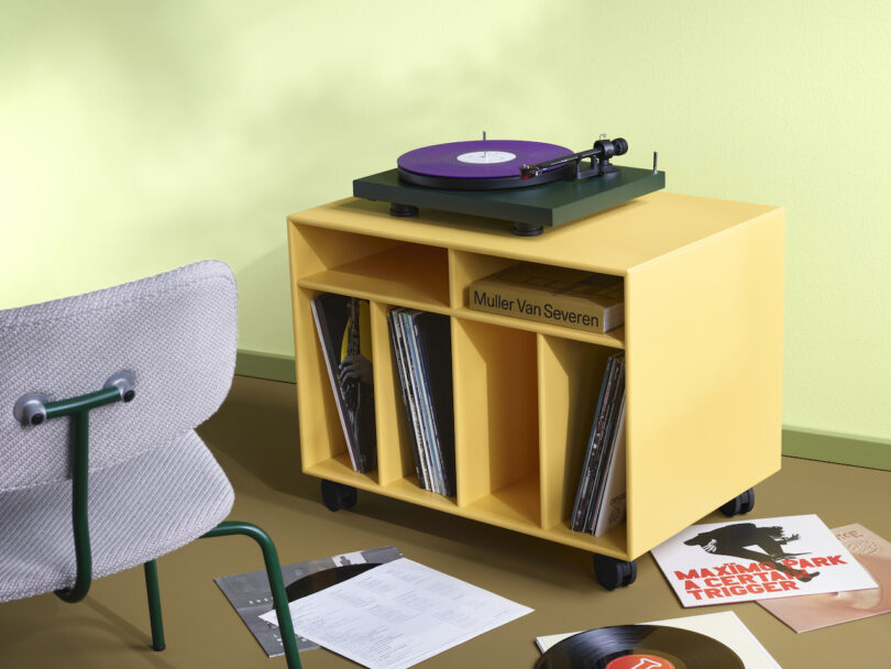 yellow vinyl storage furniture on casters holding records and record player