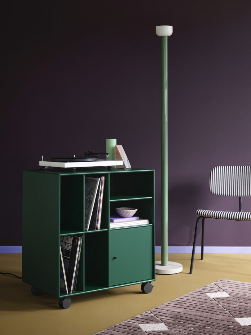 green vinyl storage furniture on casters holding records and other objects