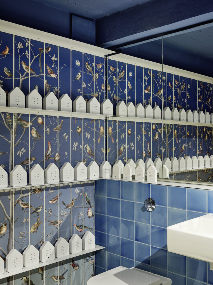 restroom with shelves of house-shaped products