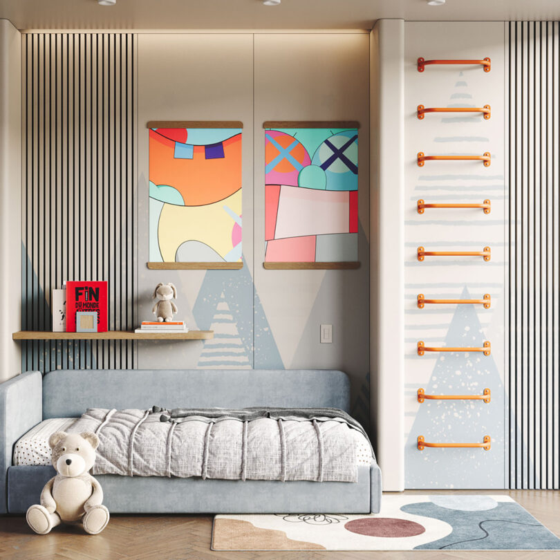 Randle Wall Climbing Handles installed onto the right side wall of a small children's bedroom decorated with abstract colorful wall art, floating shelf, modern abstract rug, slat covered walls, and a small blue-gray corner bed with a large teddy bear leaning against it.