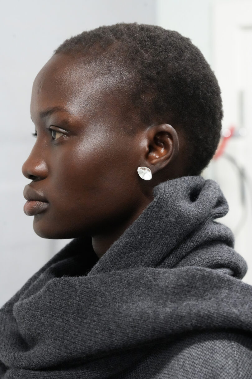 woman wearing a scarf and a silver earring