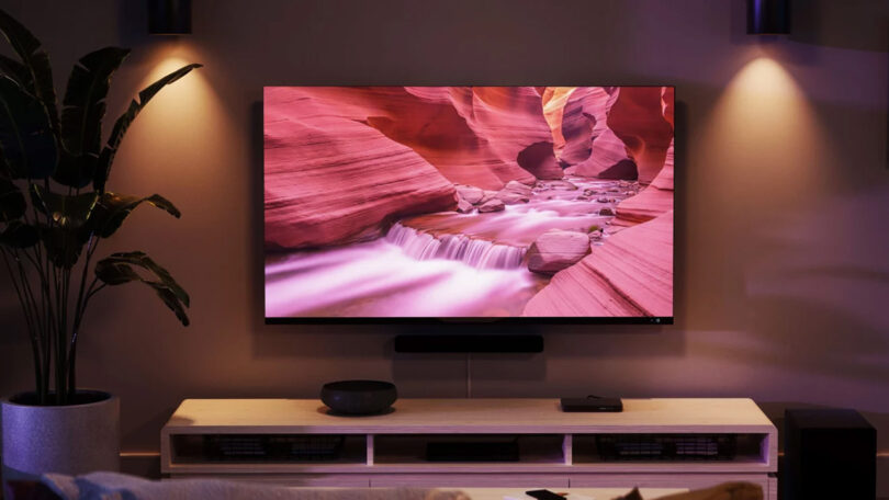 A living room with an Amazon Fire TV with a background of a rapid river in Antelope Canyon on its screen.