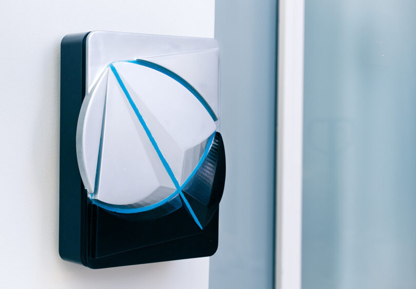 A futuristic style wall-mounted Andersen EV charger with a blue diagonal line, one of the student designs from the Andersen EV ‘Designer of Tomorrow’ competition