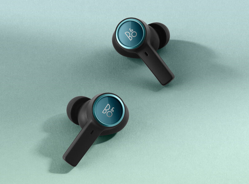 Pair of Bang & Olufsen Northern Sky Turquoise wireless earbuds with the brand's logo "B&O" imprinted across each earbud