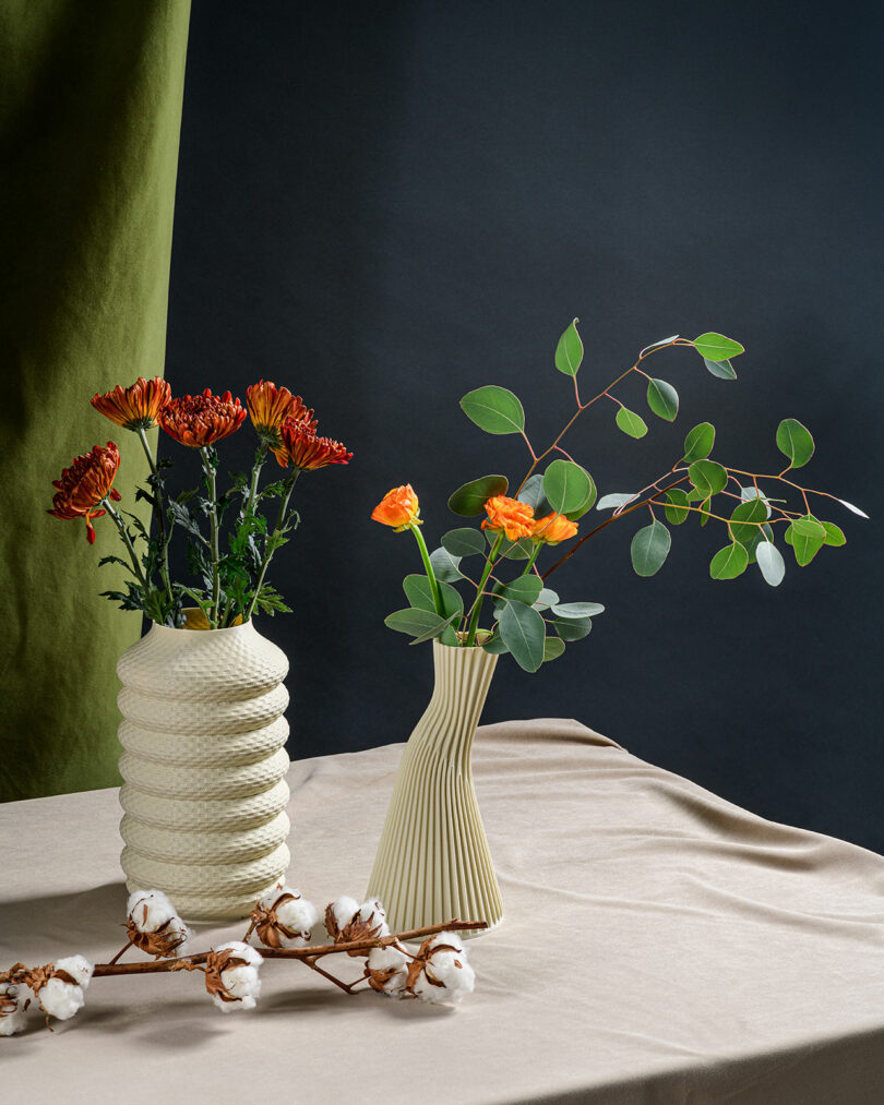 A few textured vases with flowers on a table scape.