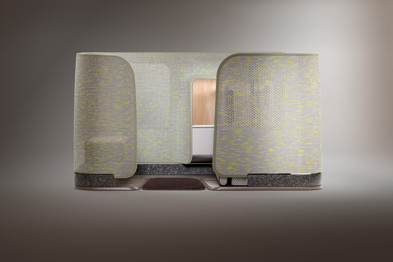 Modern stylish 3D woven textile covered airline cabin seat concept in green as viewed from the side.