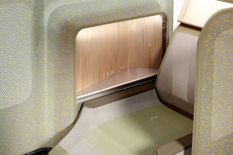 Modern airline interior with a minimalist design, featuring 3D woven textile seats and a wooden dash control armrest.