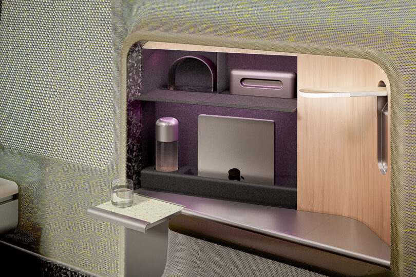 Modern airplane cabin interior with a personal entertainment system and a sleek, ergonomic design, featuring 3D woven textile in the aircraft seat design.
