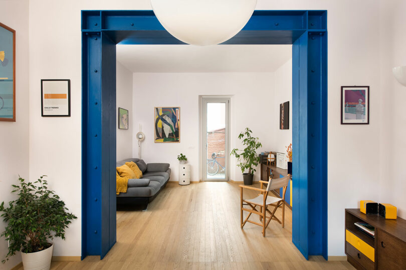 A blue doorway leads into a living room.