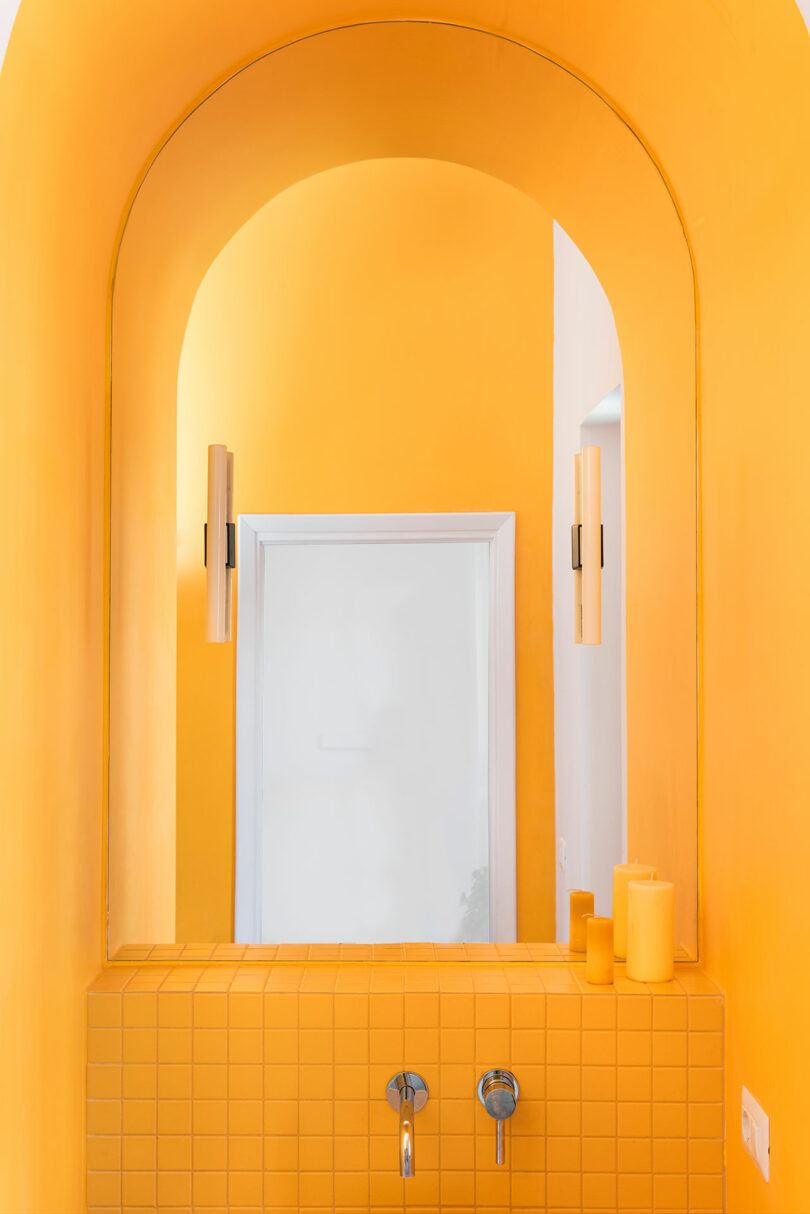 closeup of arched yellow bathroom sink