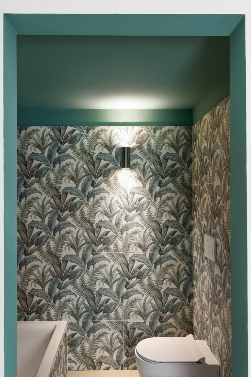 modern bathroom with tropical green wallpaper