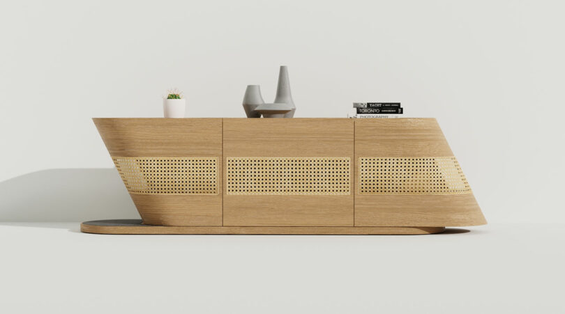 A modern wooden console with a cat on top.