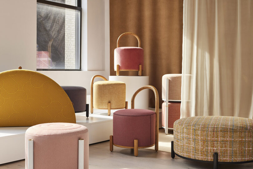 A group of colorful stools in a room.