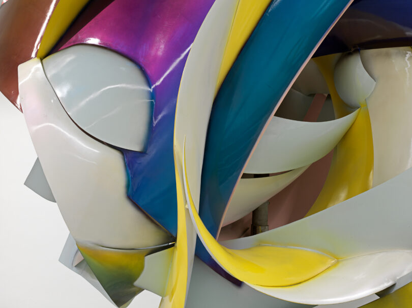 Colorful abstract sculpture with intertwined shapes.