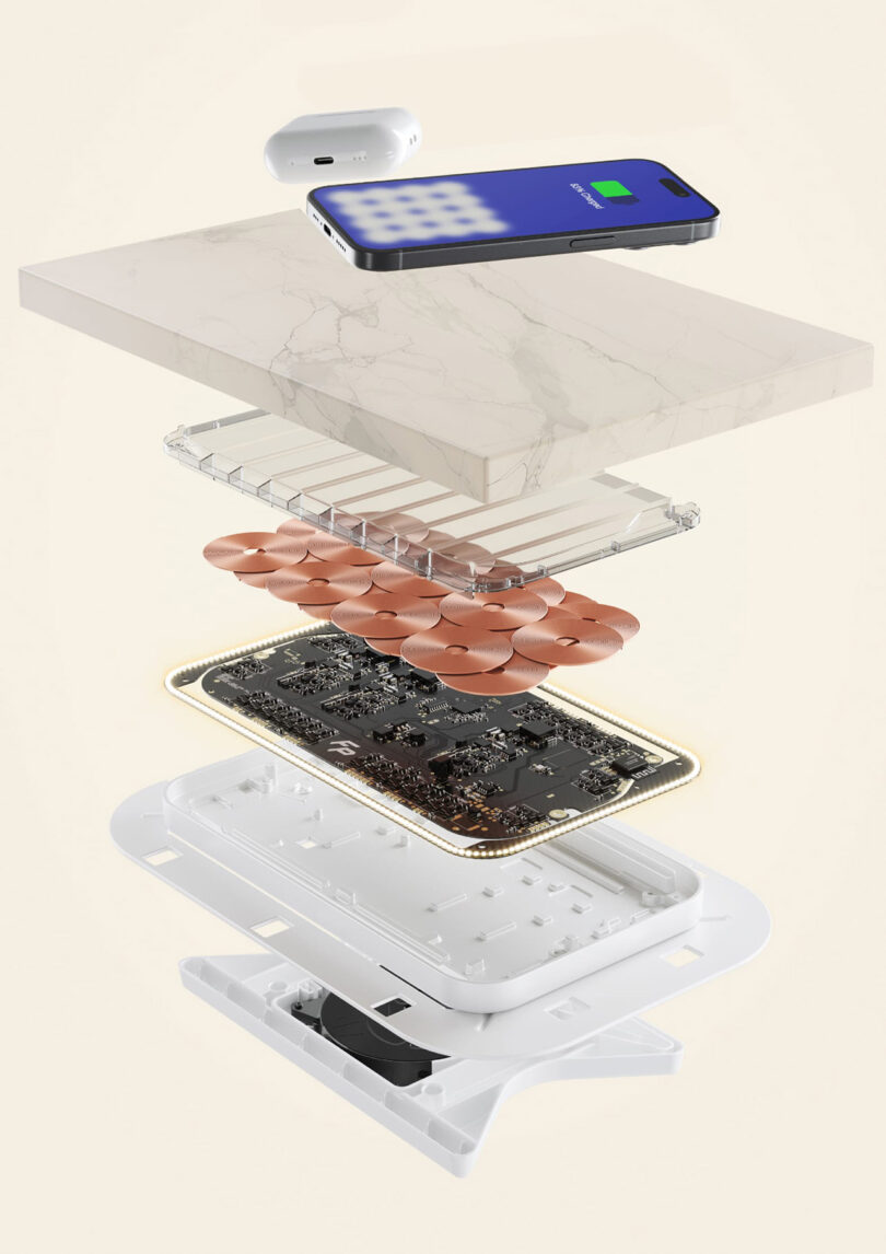 An exploded view image of Freepower's wireless charging components and a phone, using wireless charging, on top of a stone countertop.