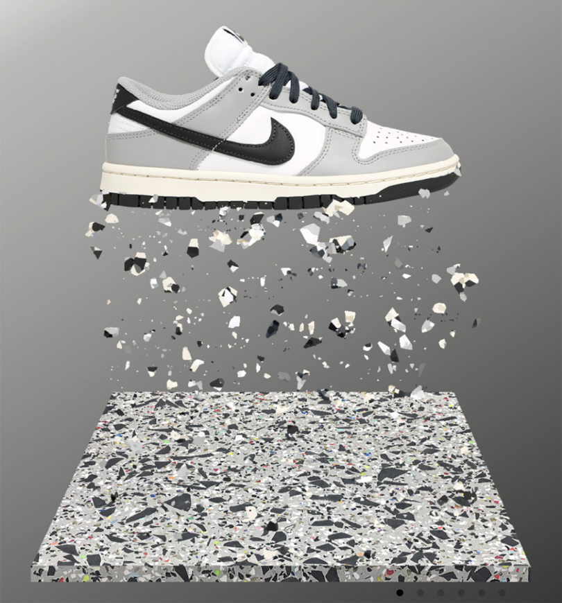 A Nike shoe suspended over a square of recycled rubber.