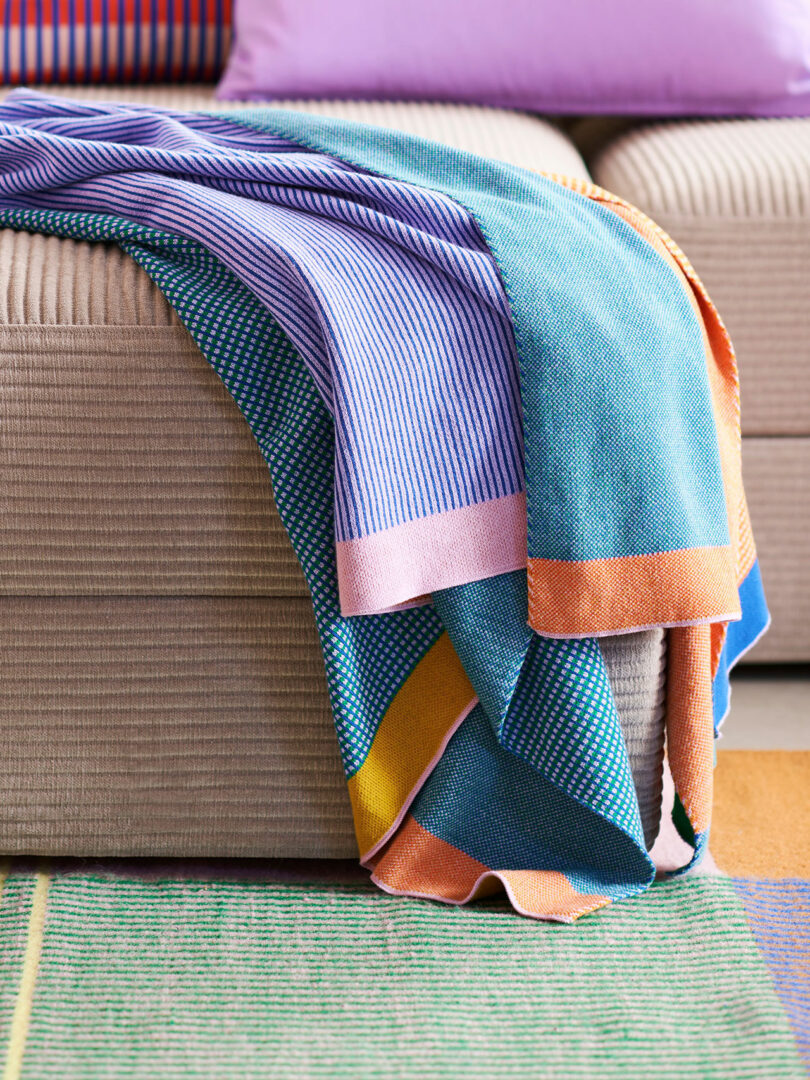 closeup of a colorful throw blanket laying across sofa ottoman