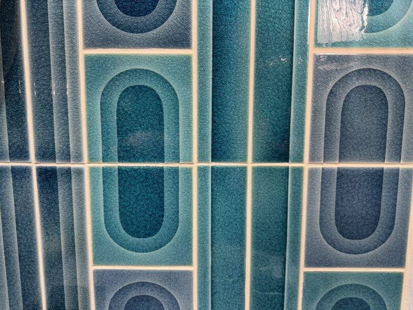 Close up of recycled material blue and white tile with graphic arch designs