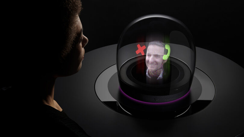 A person speaking to another person via holographic display within a domed device
