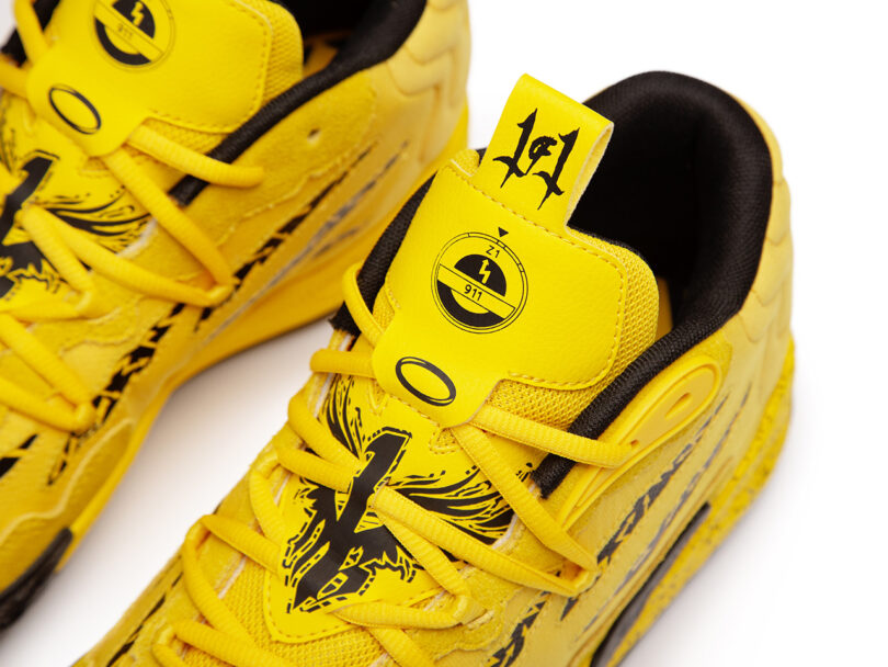 A pair of yellow sneakers from the PUMA x Porsche Basketball Collection with black and yellow designs.