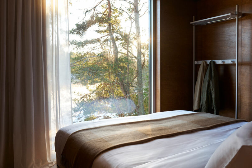Sunlit cozy hotel room with a view of the Swedish forest.