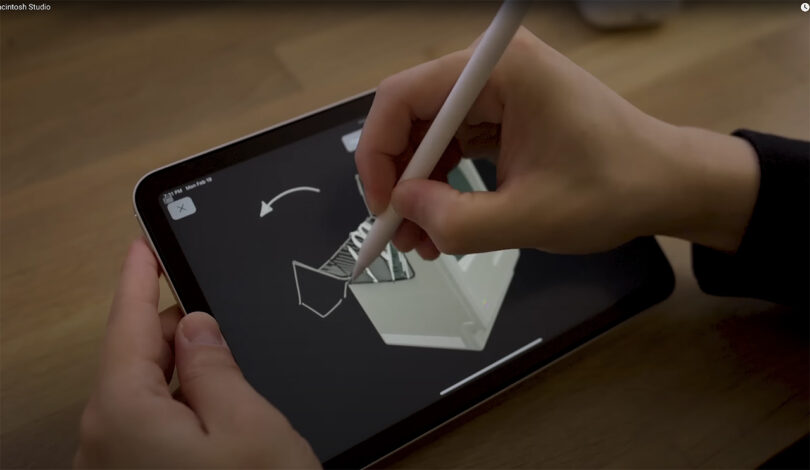 A person using an Apple pencil to draw onto a 3D printed design application on an iPad.
