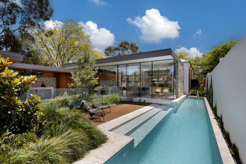 A modern house with a swimming pool in the backyard.
